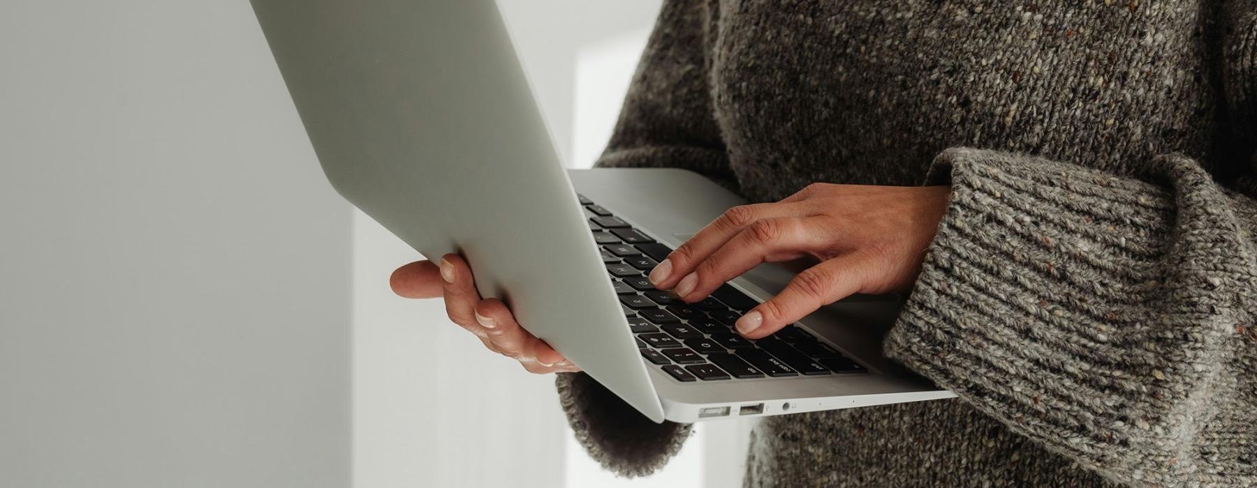 A person holding a laptop