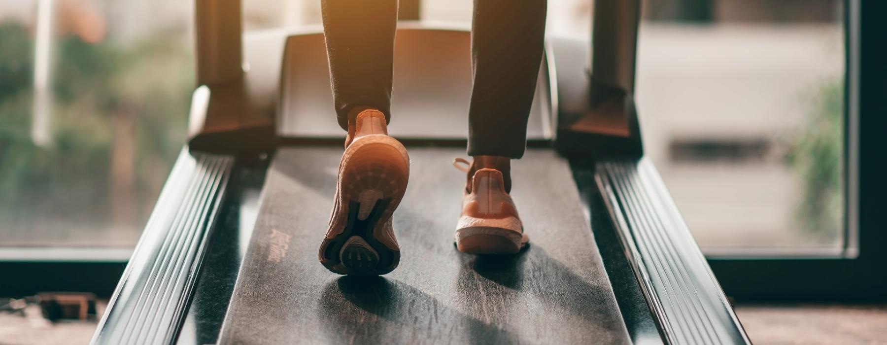 a close-up of a person's feet as they run on a treadmill